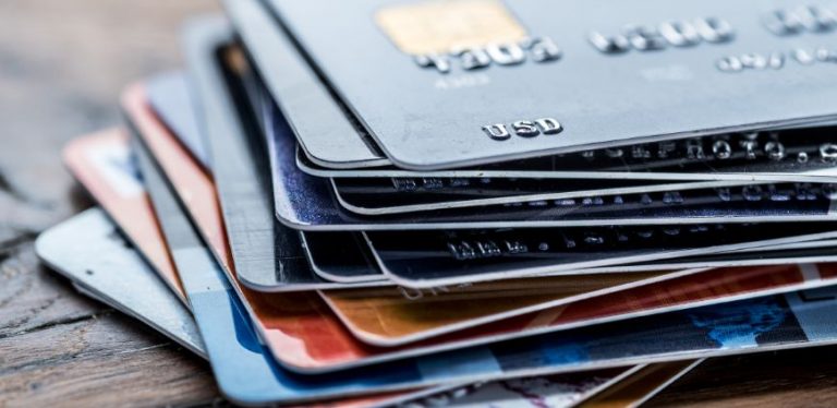 A stack of credit cards sitting on a table.