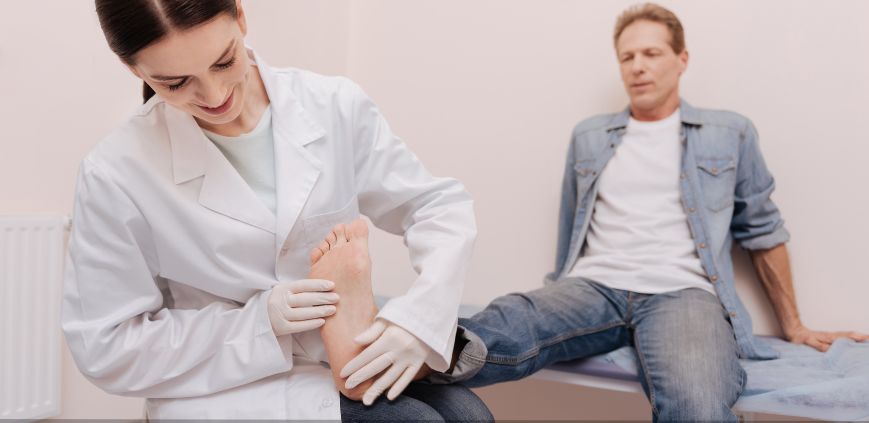 A female doctor examining a patient's foot.