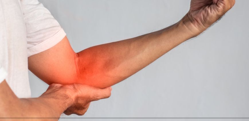 A man holding his arm up, with his elbow covered in red shades to highlight a pain point.